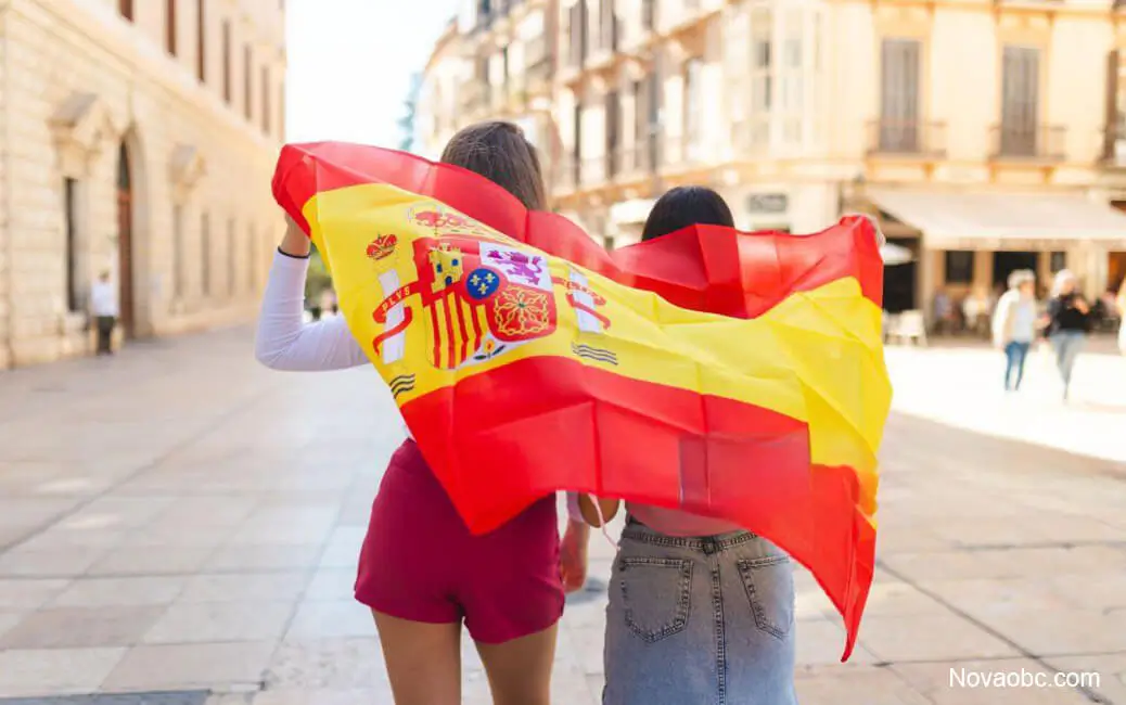 Nova OBC hand-carry logistics from Spain with two women holding Spanish flag