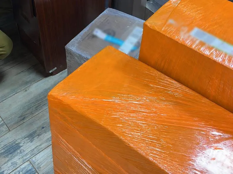 Orange shrink-wrapped OBC shipment boxes at security screening