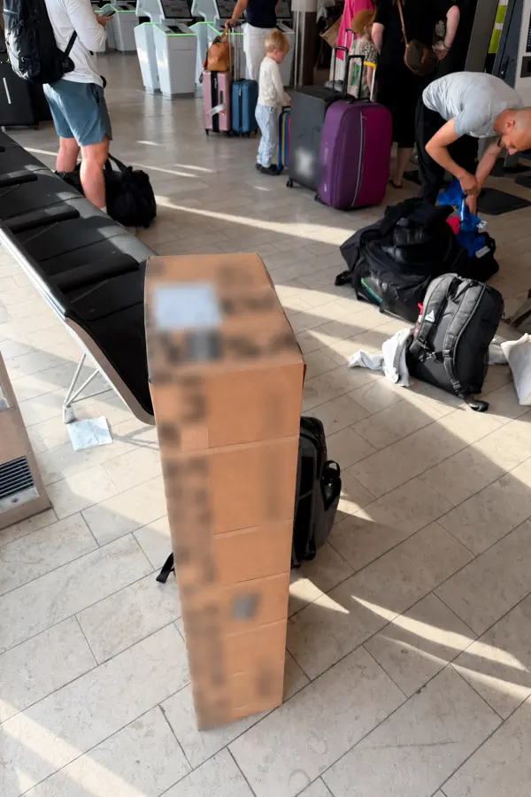 Stack of OBC shipment boxes staged at the airport before onboard courier collection