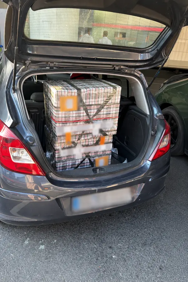 OBC shipment boxes loaded in a car trunk for transfer to the airport