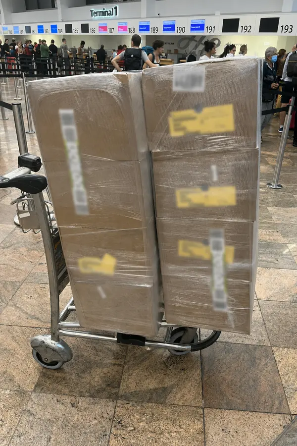 Wrapped OBC shipment boxes at airline check-in counter