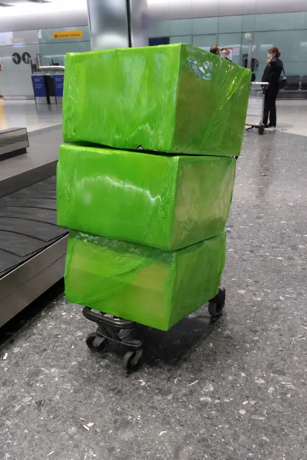 Green wrapped OBC shipment boxes ready for onboard courier transport