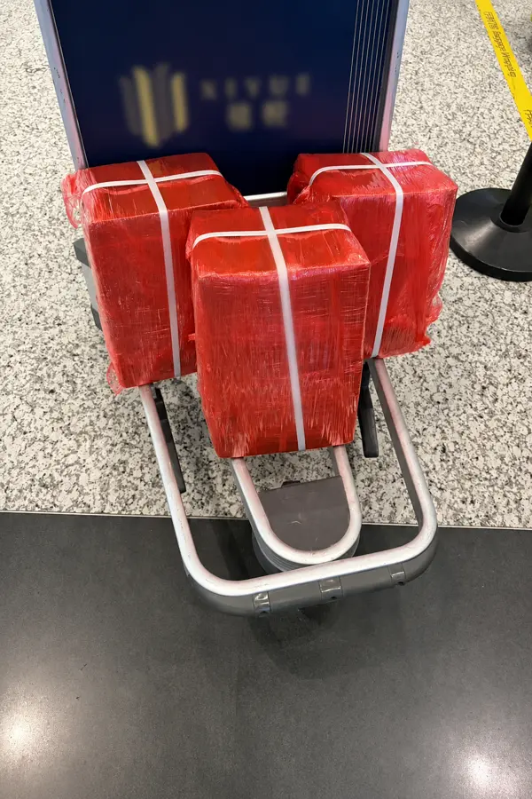 Red wrapped OBC shipment packages ready for onboard courier transport
