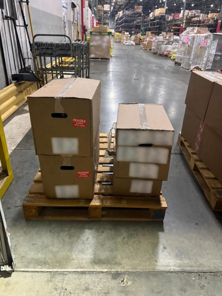Four cartons of automotive parts bundled into two checked-baggage pieces at Cleveland Airport for an OBC flight to Laredo